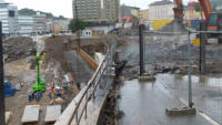 15.09.15 - Blick ber dem Bretterzaun - Zuzerst wird der alte Fahrbahnbelag ausgebaut.